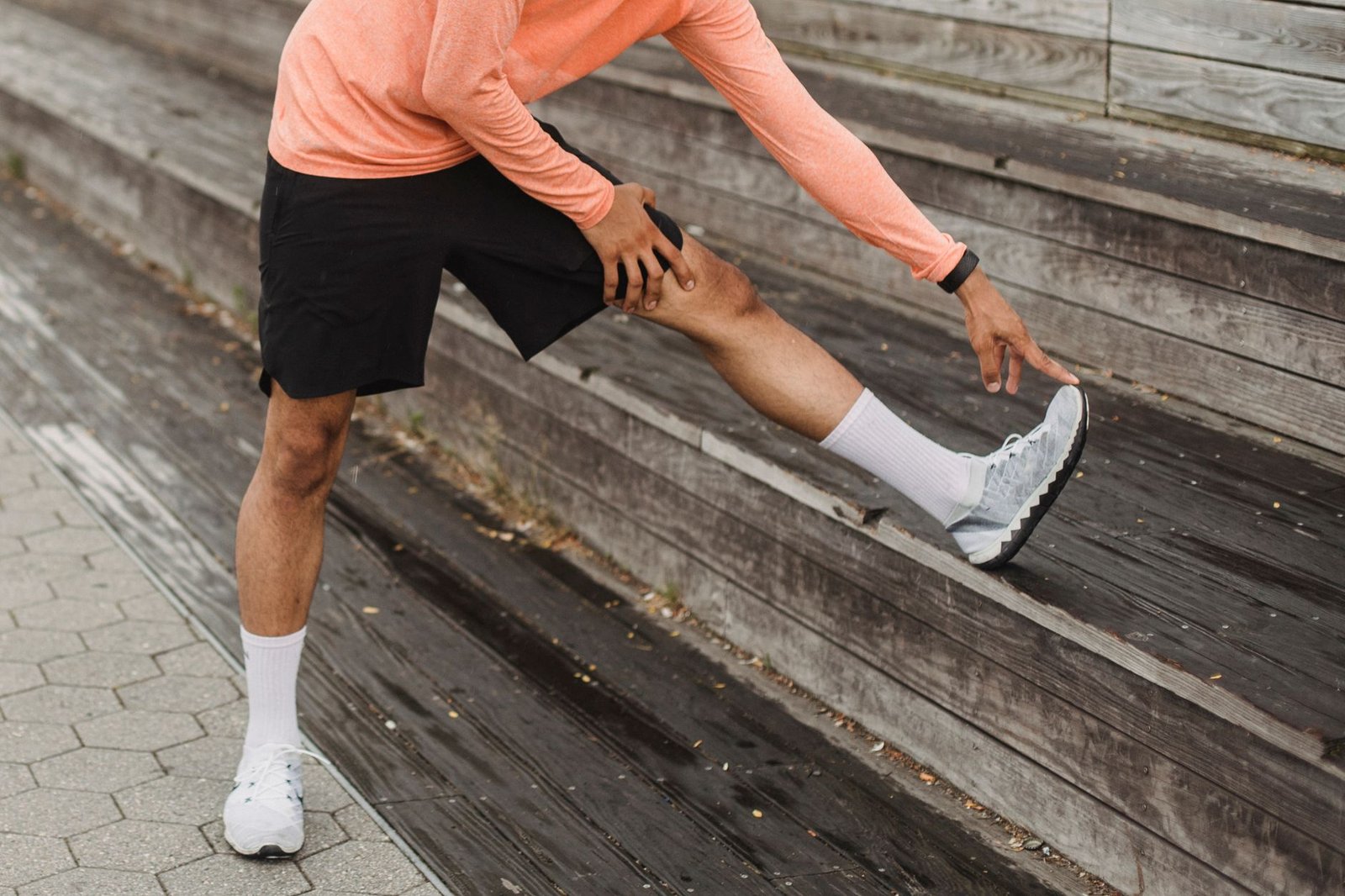 Close-up of runner stretching hip muscles during warm-up