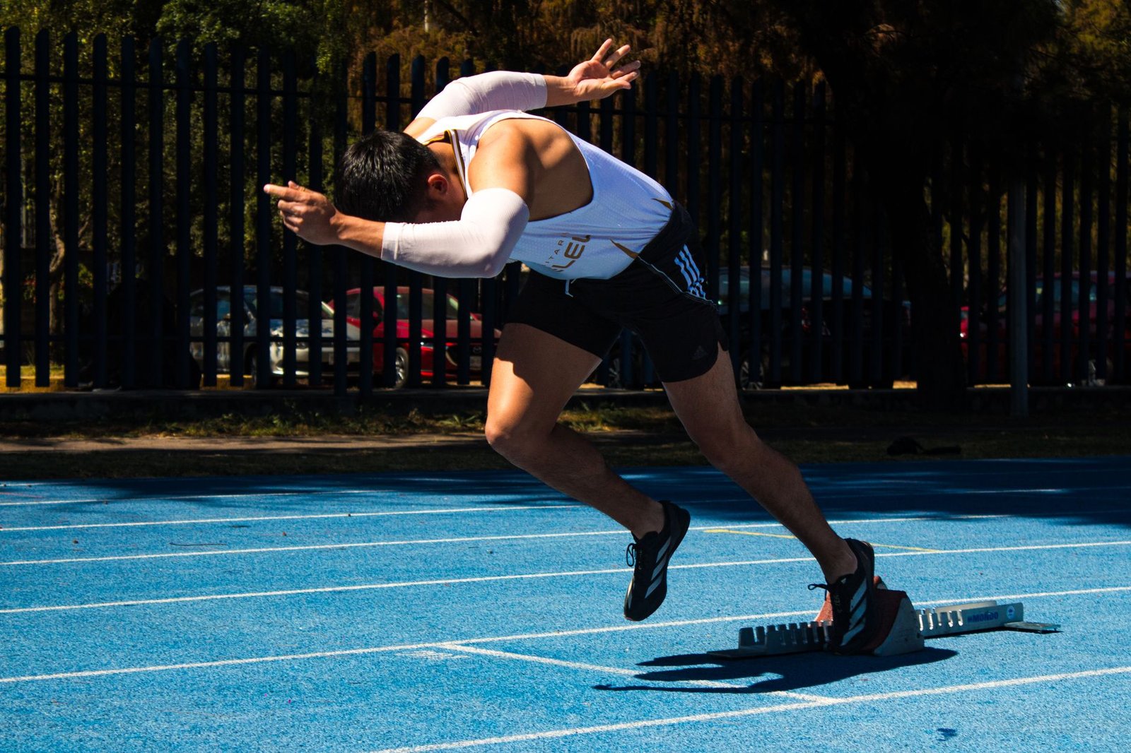 Athlete hydrating with electrolyte drink during summer workout