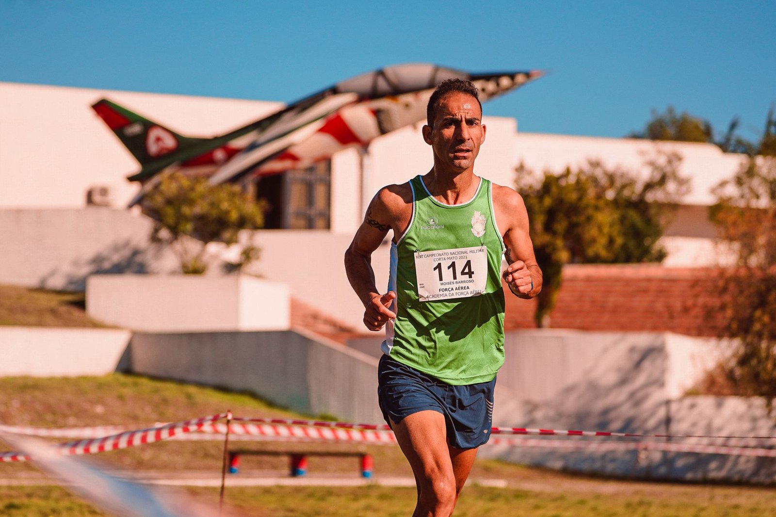 Coach demonstrating hill sprint intervals with stopwatch timing
