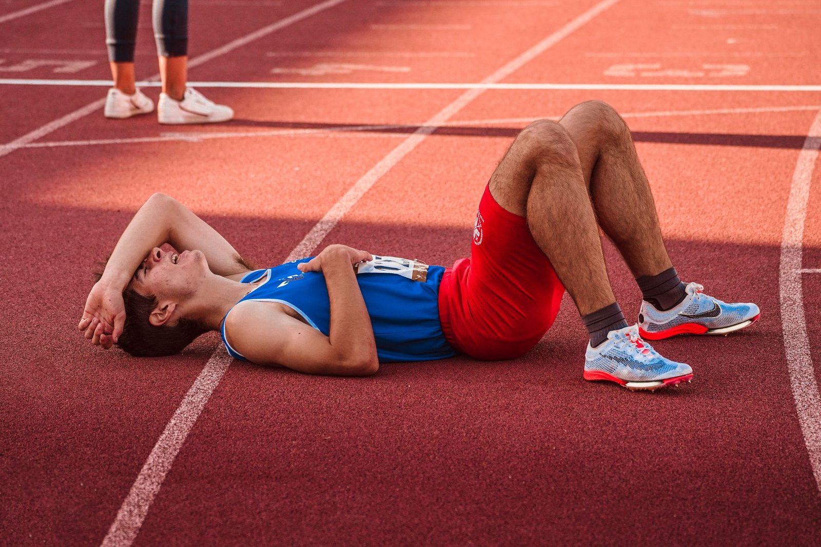 Athlete hydrating with water bottle and electrolyte mix recovery