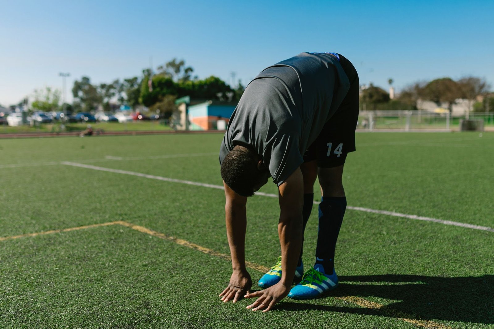 Windy trail runner doing dynamic leg swings warm-up