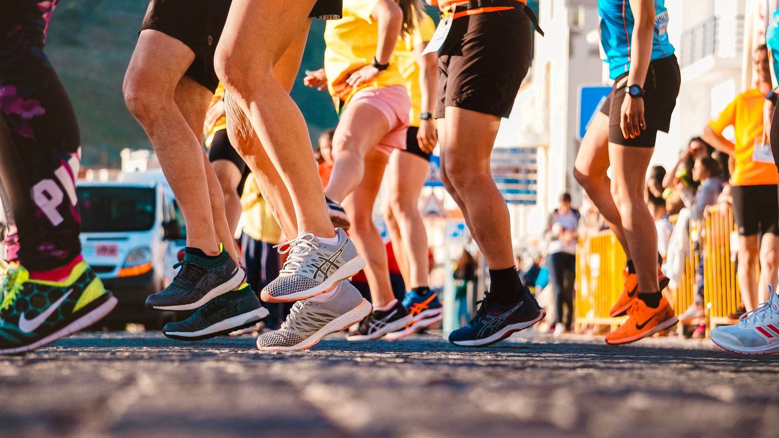Close-up of compression socks supporting feet on pavement