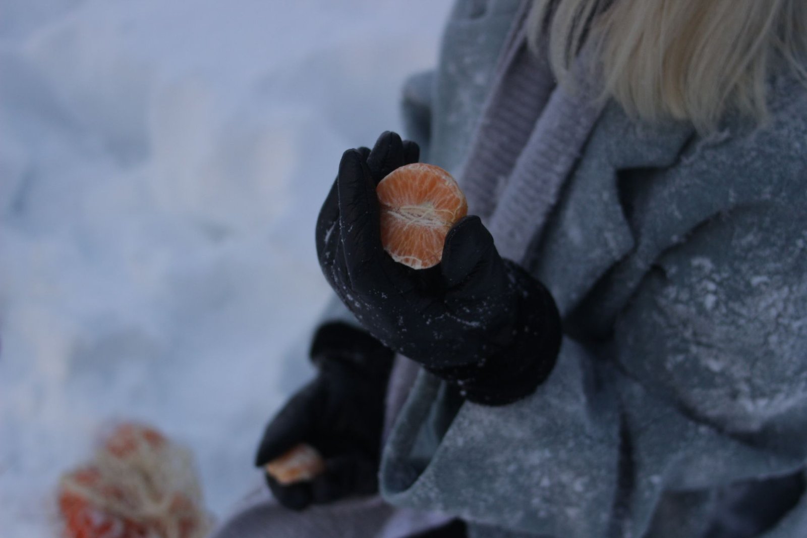 Close-up of insulated gloves and scarf against cold wind