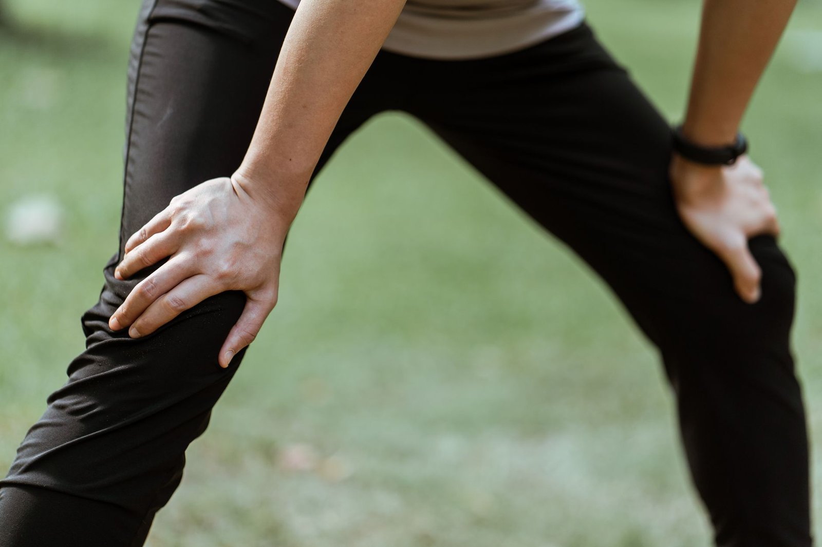 Cyclist and runner using foam roller on river path