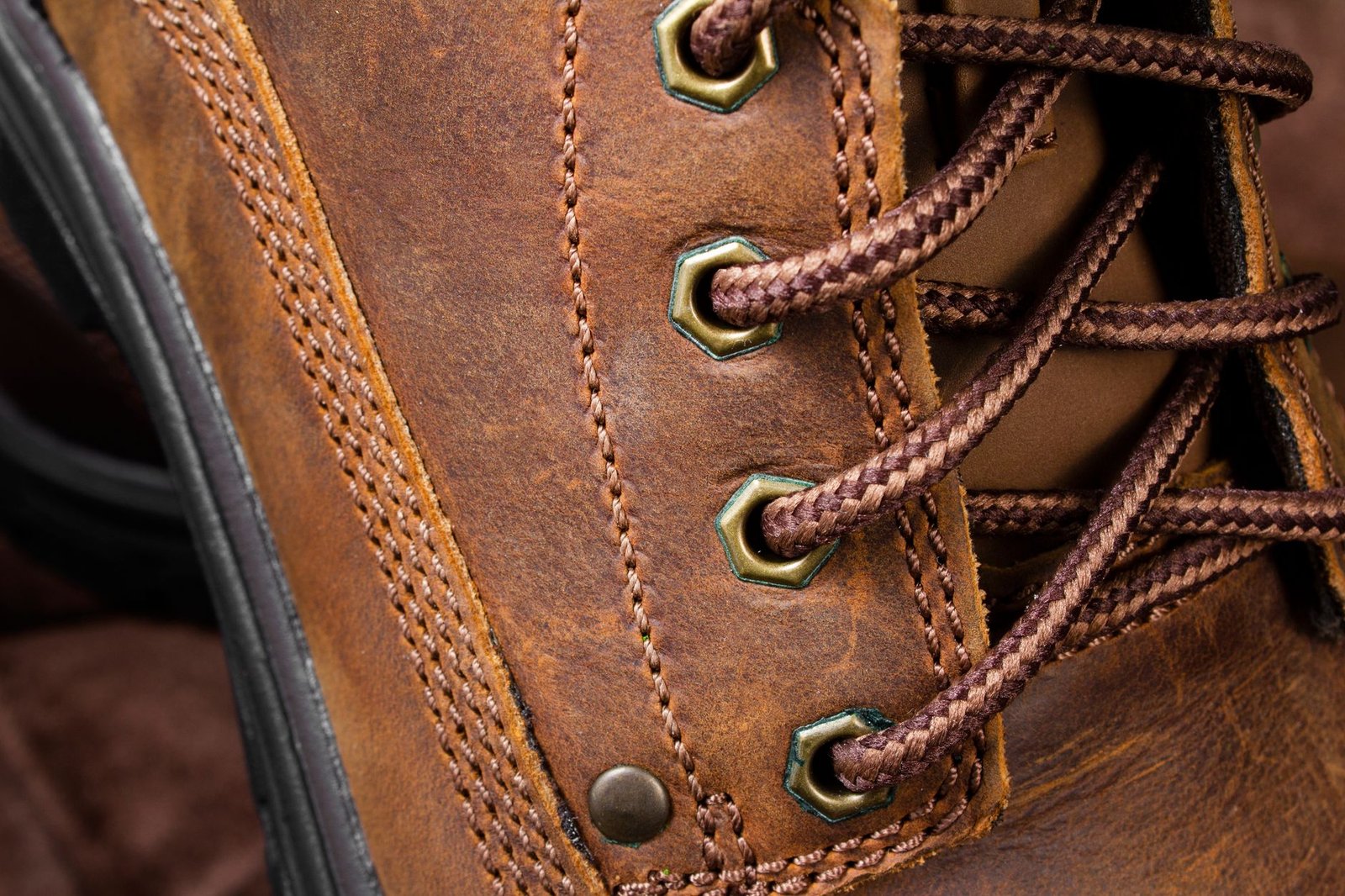 Person adjusting shoe fit to prevent seam blistering