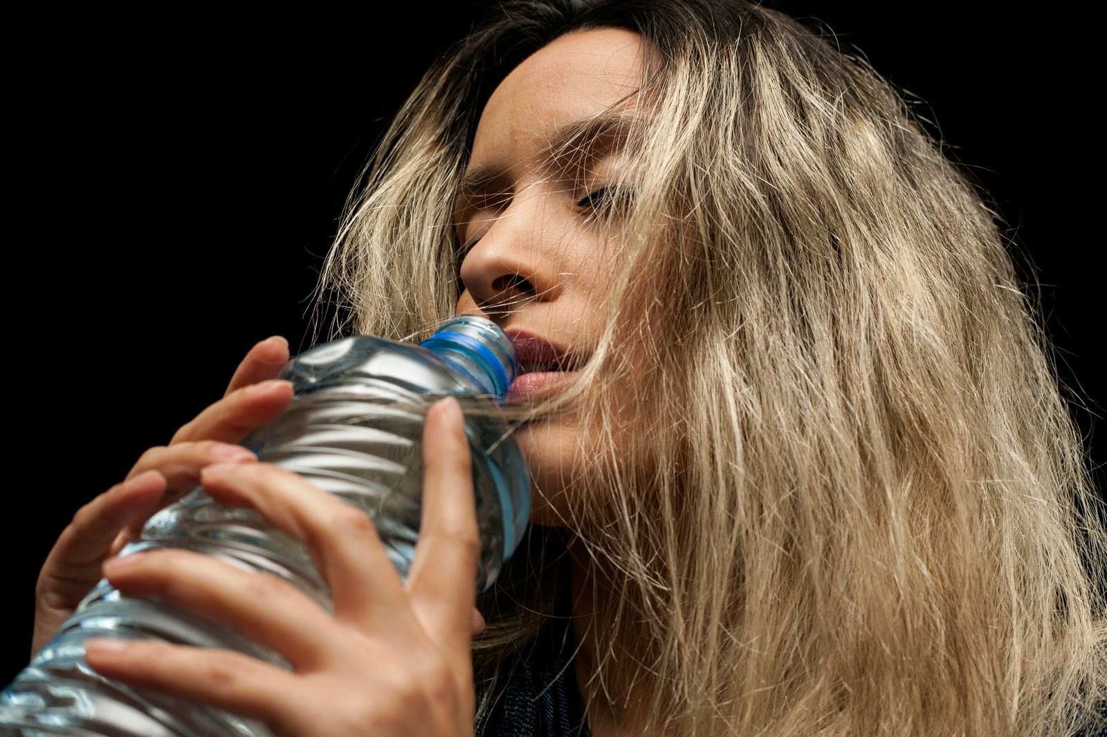 Hydration bottle tilted correctly to prevent slosh and discomfort