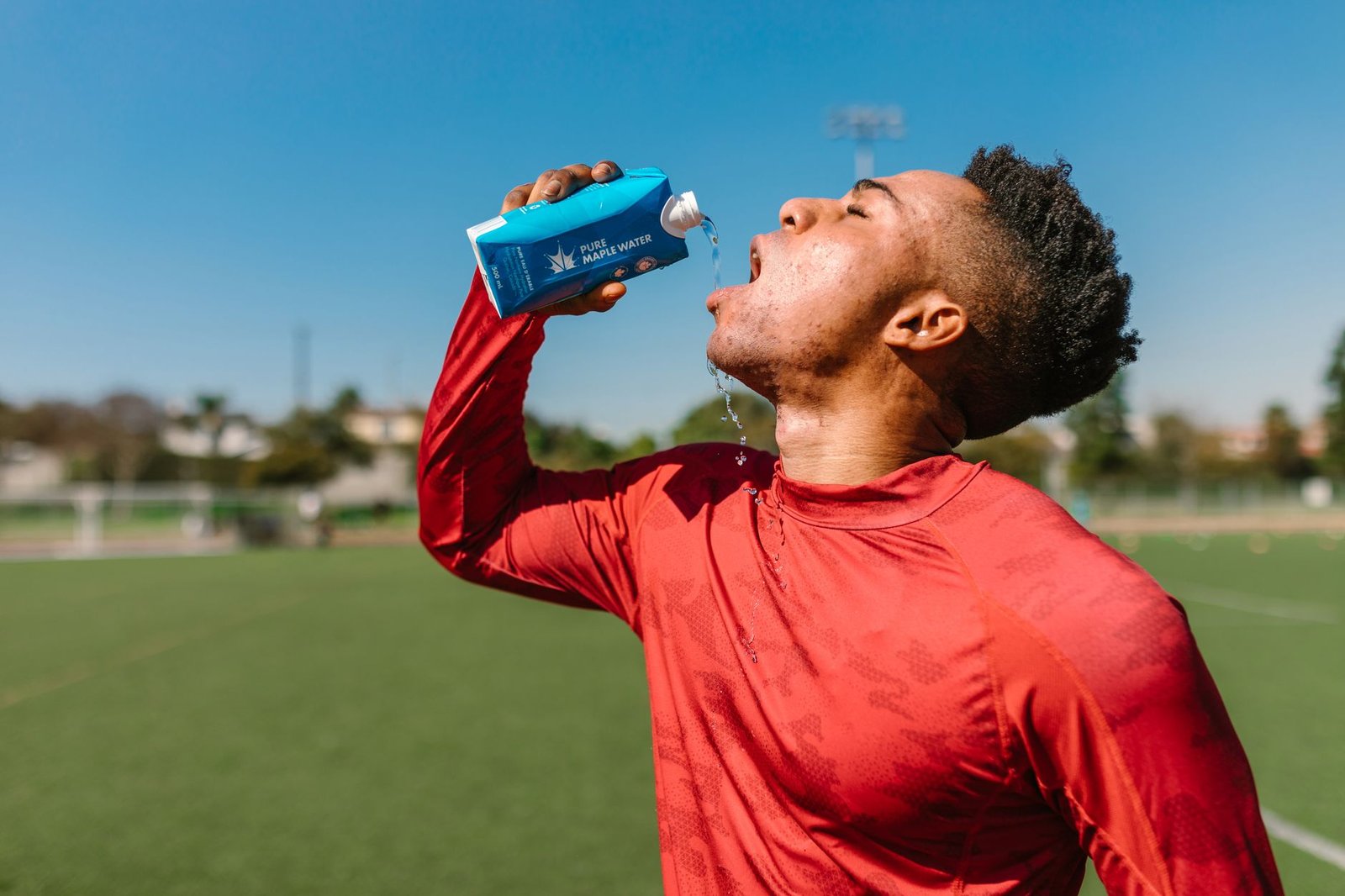 Athlete sipping small amounts, practicing how to avoid overdrinking