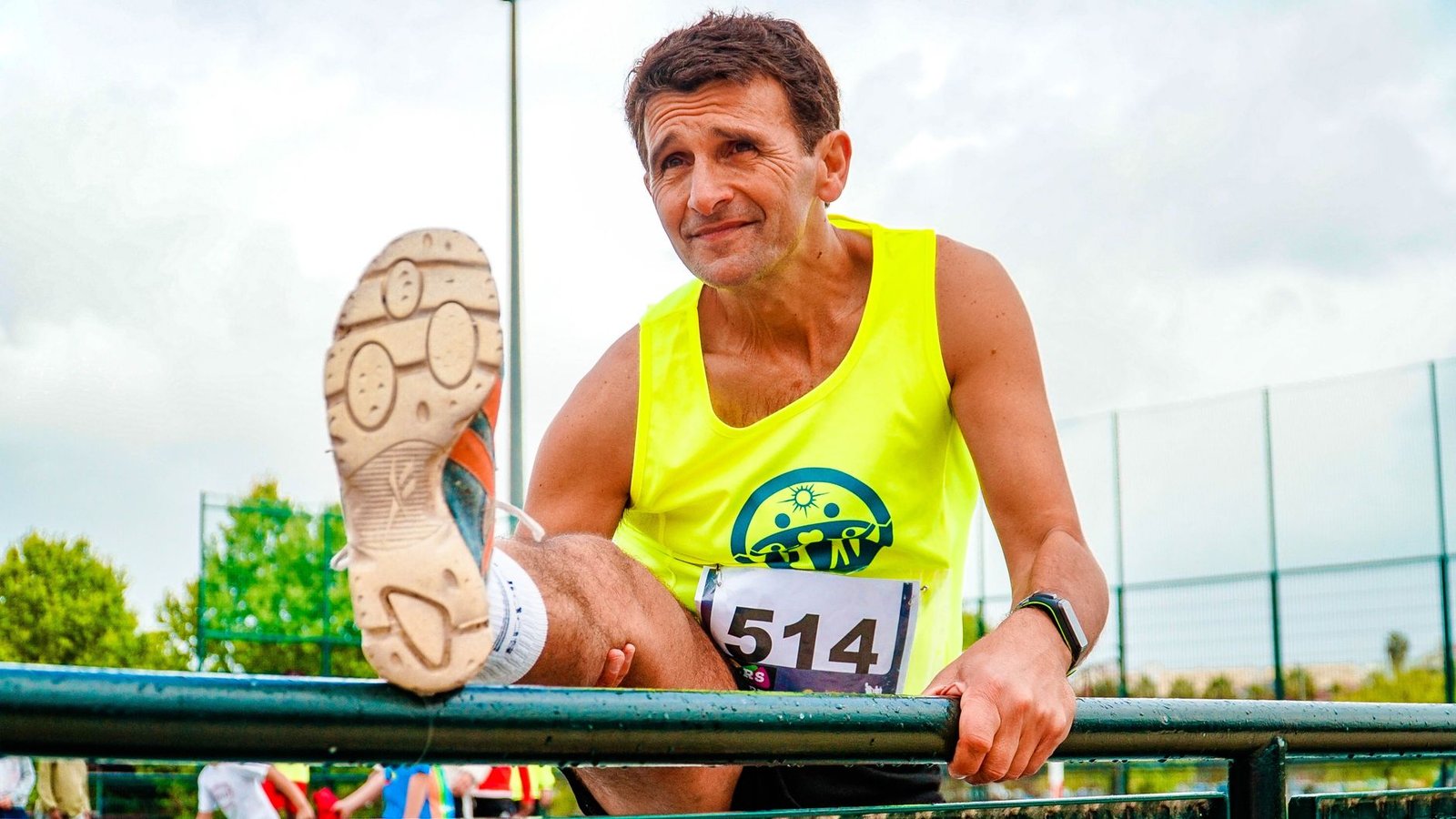 Hamstring stretch during post-race stretching routine for marathon recovery