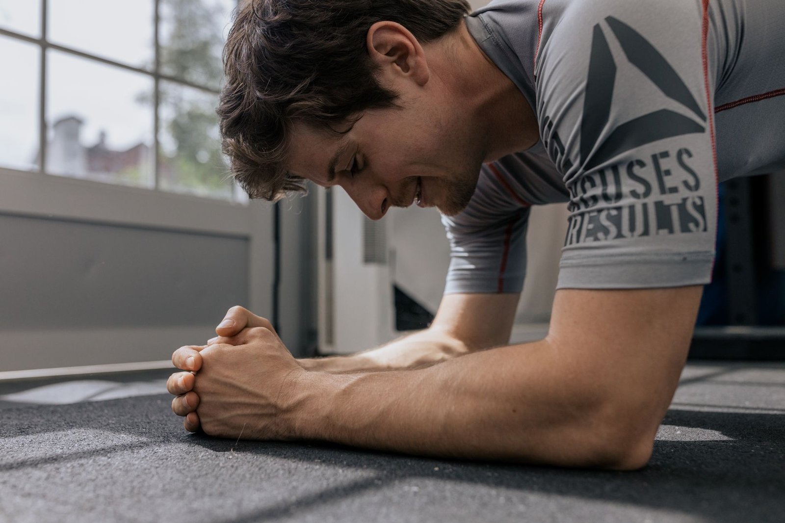 Trainer demonstrating dead bug exercise for road-ready control