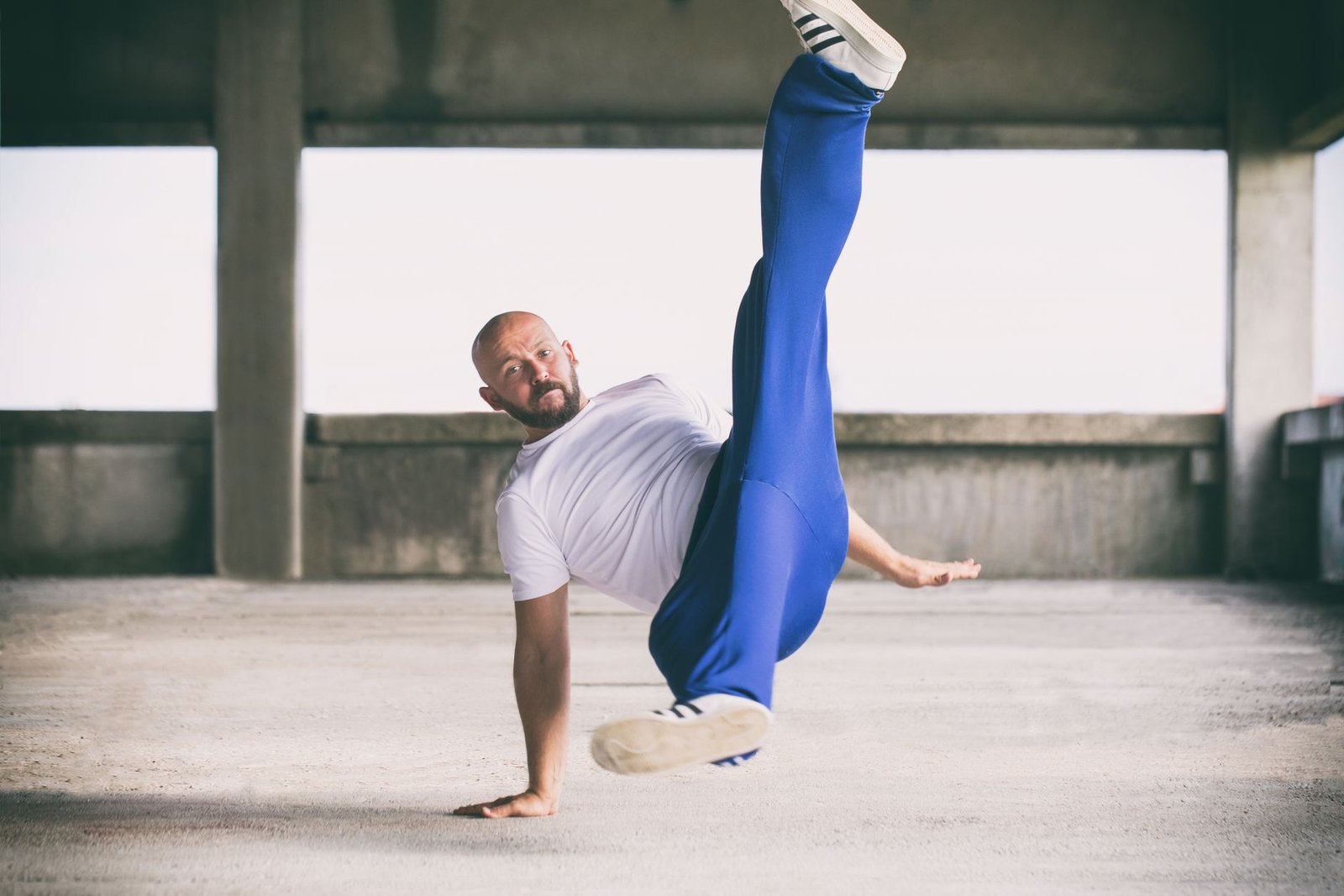 Physiotherapist demonstrating hip flexor stretch on bench