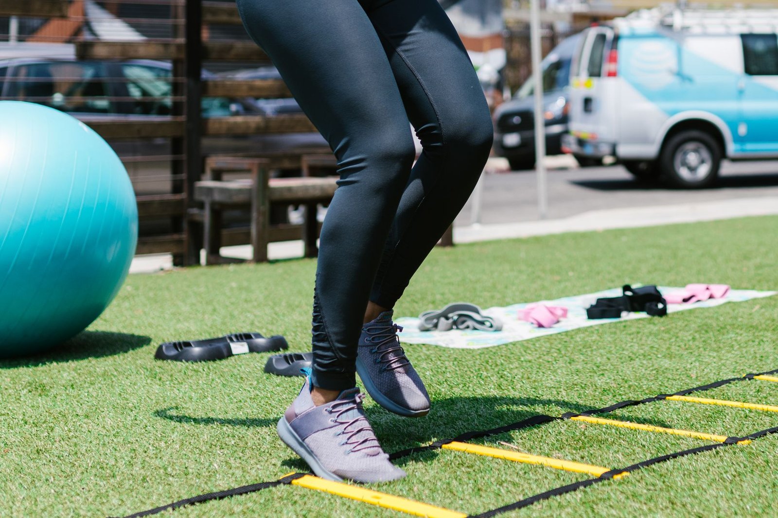 Coach guiding foot strike alignment during strength-to-stride integration drills