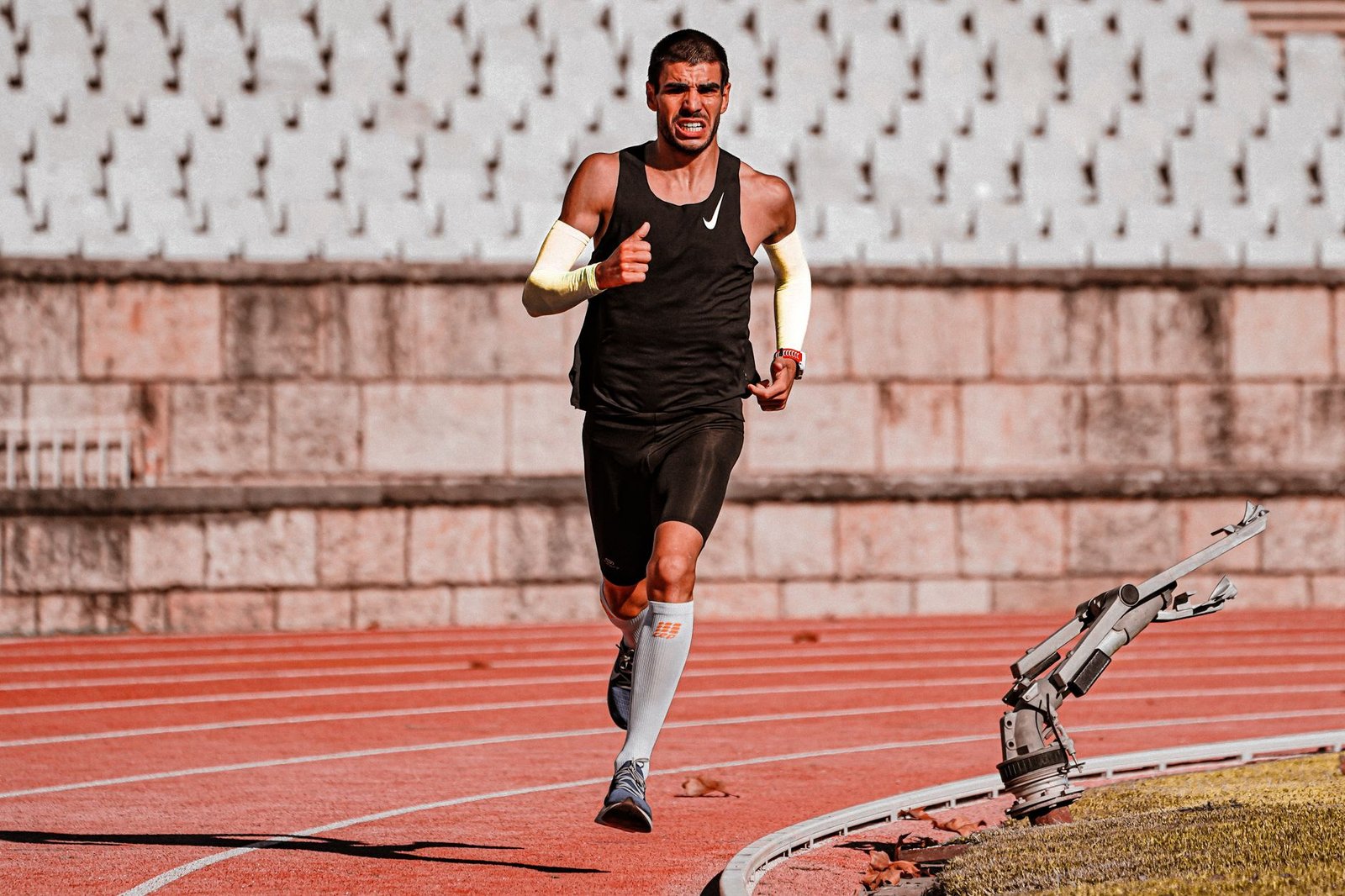 Coach guiding marathoner through compound lifts technique