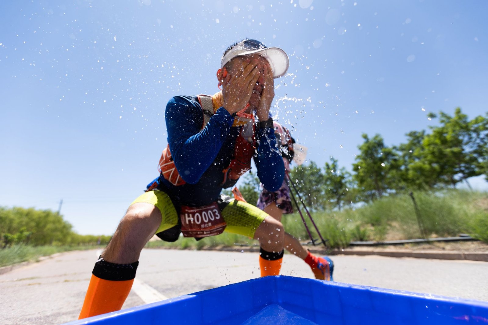 Cyclists monitoring hydration bottles during humid track sessions