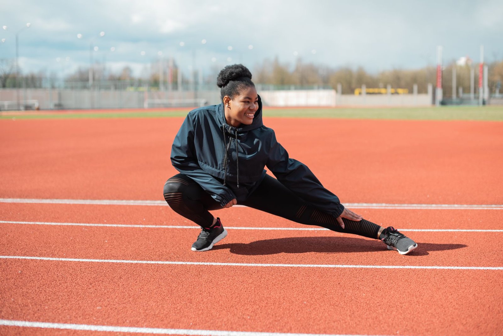 Runner performing hamstring mobility stretches in London pathway