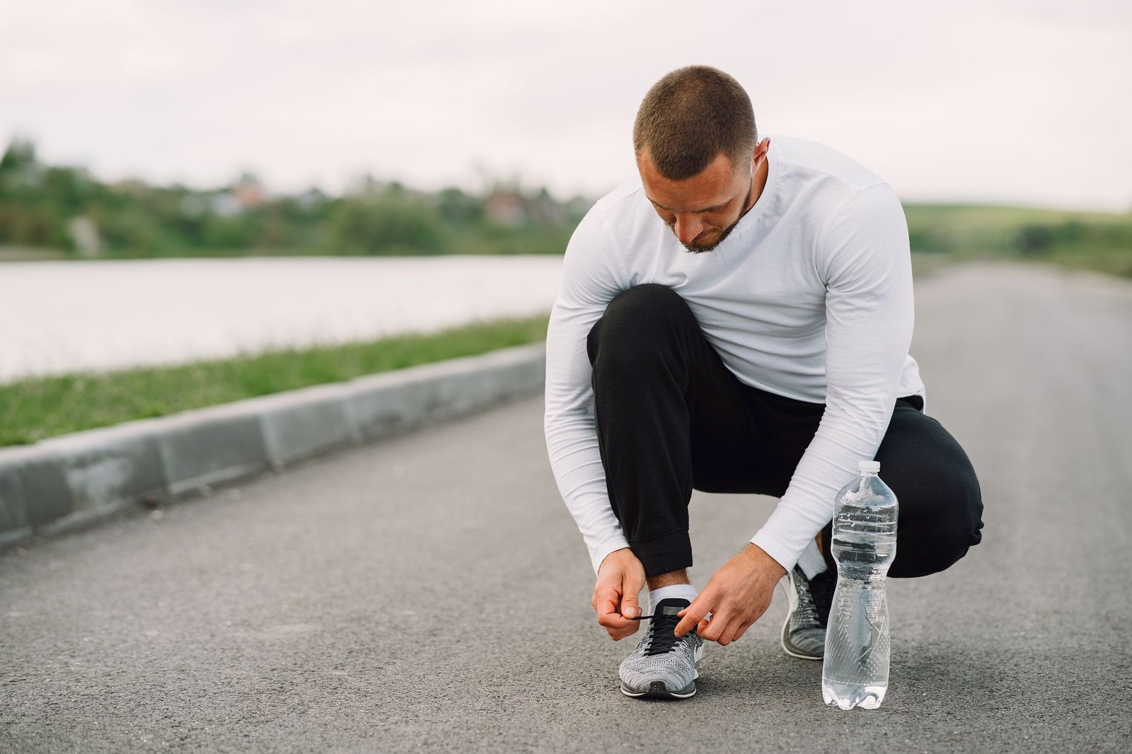 Runner checking hydration plan before long run outdoors