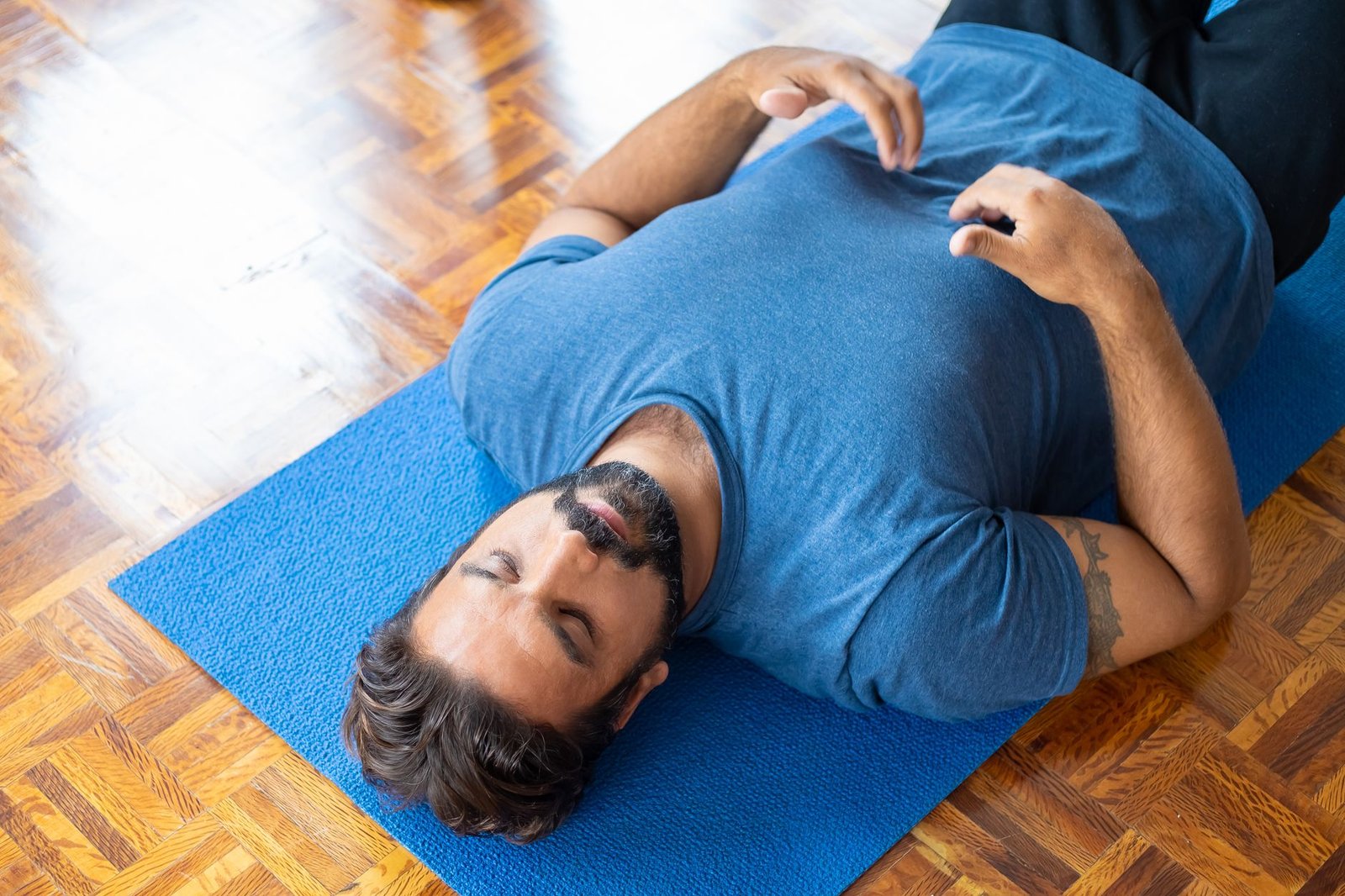 Close-up of focused runner using controlled breathing technique