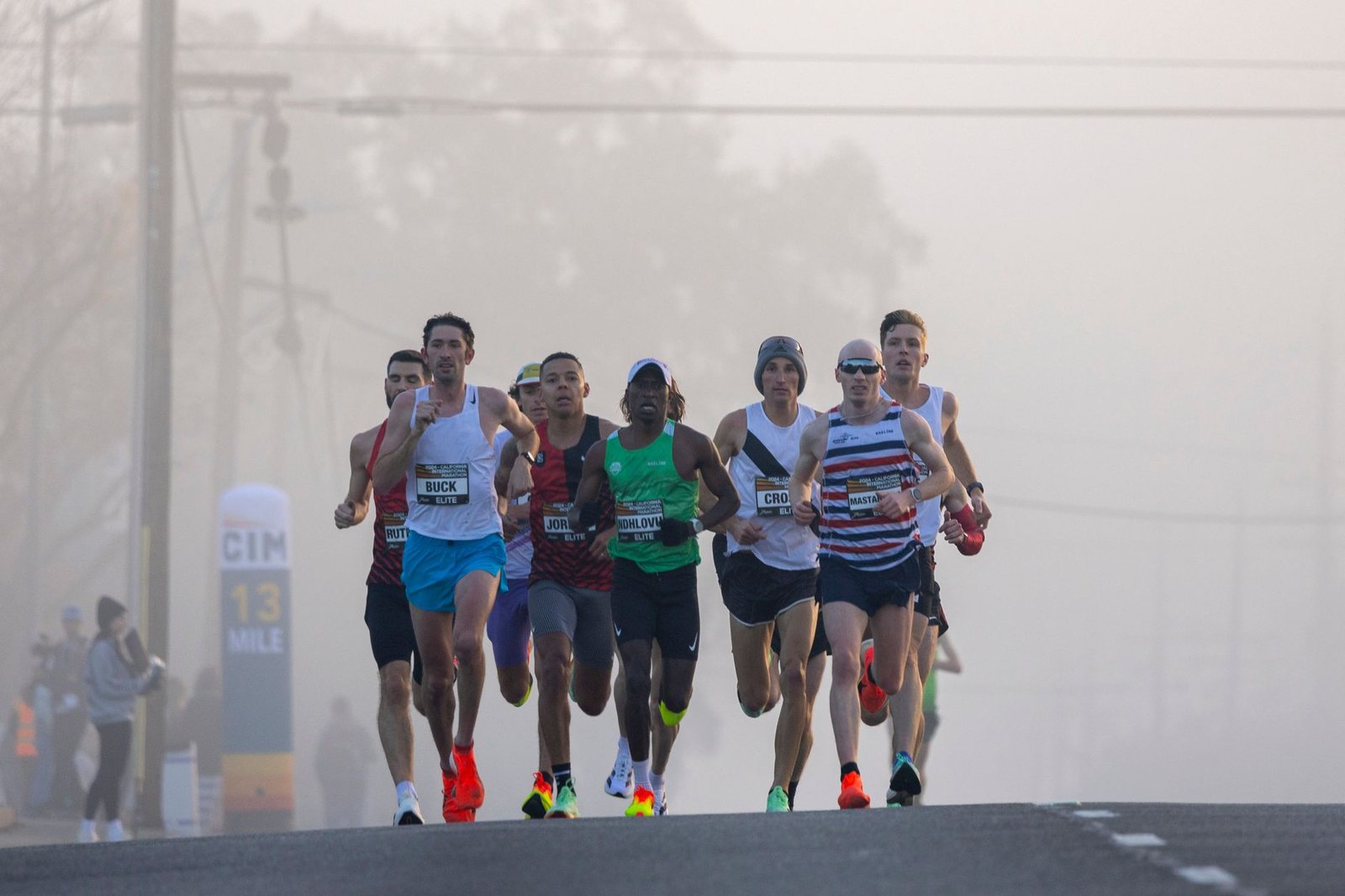 Cadence-focused athlete maintaining form during late-mile fatigue