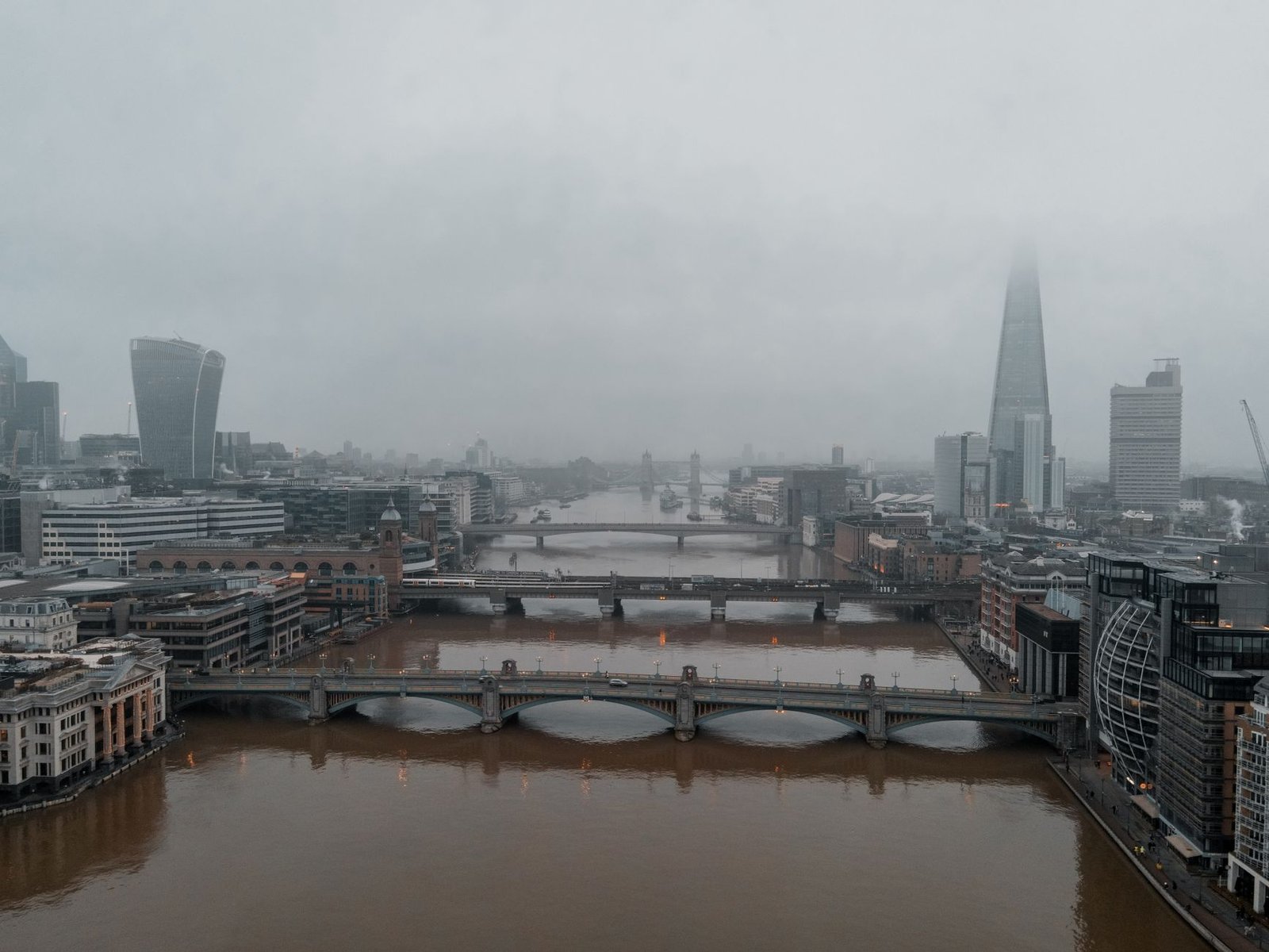 Cyclist using interval timers in cool London rain